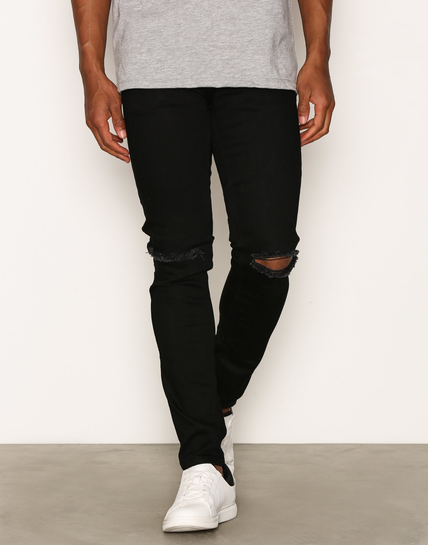black jeans with rips in knees